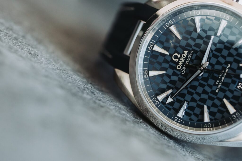 OMEGA Aqua Terra Tokyo 2020 lying on a grey marble surface